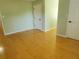 A spacious bedroom featuring hardwood floors, neutral wall colors, and natural light at 2615 Southern Oaks Pl, Plant City, FL 33566