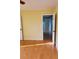 Bedroom with hardwood floors, neutral walls, and entrances to other rooms at 2615 Southern Oaks Pl, Plant City, FL 33566