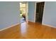 This bedroom features wood floors, neutral walls, and a garden view at 2615 Southern Oaks Pl, Plant City, FL 33566