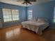 Bedroom with wood floors, blue walls, and lots of natural light at 2615 Southern Oaks Pl, Plant City, FL 33566