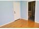 This bedroom features wood floors, neutral walls, and a bathroom entrance at 2615 Southern Oaks Pl, Plant City, FL 33566
