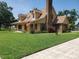 Inviting two-story home boasting a well-kept lawn, brick chimney, and classic dormer windows at 2615 Southern Oaks Pl, Plant City, FL 33566