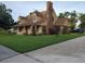 Inviting two-story home showcasing a brick chimney and attractive landscaping at 2615 Southern Oaks Pl, Plant City, FL 33566