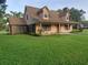 Charming two-story home featuring a brick facade, dormer windows, and a well-manicured lawn at 2615 Southern Oaks Pl, Plant City, FL 33566