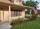 Front exterior featuring shutters, an American flag and manicured lawn at 2615 Southern Oaks Pl, Plant City, FL 33566