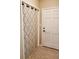 Hallway with patterned floors, white walls and curtains, and a white door at 2615 Southern Oaks Pl, Plant City, FL 33566