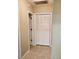 Hallway with closet, bi-fold doors, and neutral paint and flooring at 2615 Southern Oaks Pl, Plant City, FL 33566