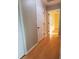 Light filled hallway featuring hardwood floors, with access to several rooms at 2615 Southern Oaks Pl, Plant City, FL 33566