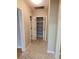 Hallway featuring neutral paint, patterned floors, and an open closet at 2615 Southern Oaks Pl, Plant City, FL 33566