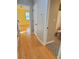 Hallway with hardwood floors leading to bathroom and bedroom areas at 2615 Southern Oaks Pl, Plant City, FL 33566