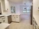 Well-lit kitchen boasting white cabinets, stainless steel appliances, and tile flooring, perfect for cooking and entertaining at 2615 Southern Oaks Pl, Plant City, FL 33566