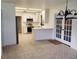 Modern kitchen featuring white cabinets, stainless steel appliances, and tiled floors, creating a clean and stylish space at 2615 Southern Oaks Pl, Plant City, FL 33566