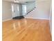 Bright living room with gleaming hardwood floors, staircase, and ample natural light creating a welcoming atmosphere at 2615 Southern Oaks Pl, Plant City, FL 33566