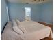 A spacious primary bedroom features a large bed, blue walls and hardwood floors at 2615 Southern Oaks Pl, Plant City, FL 33566