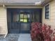 View of the screened-in porch with entry door and ceiling fan at 2615 Southern Oaks Pl, Plant City, FL 33566