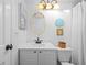 Bright bathroom featuring white vanity, decorative mirror, and coastal decor, offering a clean, inviting space at 2665 Sequoia Ter # 306, Palm Harbor, FL 34683