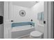 Cozy bathroom with a bathtub and a toilet, accented with a blue tile backsplash at 2665 Sequoia Ter # 306, Palm Harbor, FL 34683
