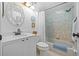 Bright bathroom featuring white vanity, decorative mirror, and tub shower, offering a clean, inviting space at 2665 Sequoia Ter # 306, Palm Harbor, FL 34683