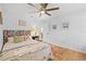Bright bedroom featuring hardwood floors, stylish headboard, and fresh, white walls at 2665 Sequoia Ter # 306, Palm Harbor, FL 34683