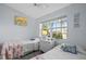 Charming bedroom features two twin beds, natural light from window, and decorative elements creating a serene atmosphere at 2665 Sequoia Ter # 306, Palm Harbor, FL 34683