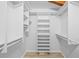 Spacious walk-in closet with built-in shelving units and wood floors at 2665 Sequoia Ter # 306, Palm Harbor, FL 34683