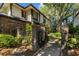 Inviting two-story home with a brick accent wall and decorative garden at 2665 Sequoia Ter # 306, Palm Harbor, FL 34683