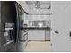 Bright kitchen with stainless steel appliances, black counters, and pendant lighting at 2665 Sequoia Ter # 306, Palm Harbor, FL 34683