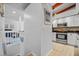 Entryway view of kitchen featuring stainless appliances, granite counters, and ample storage at 2665 Sequoia Ter # 306, Palm Harbor, FL 34683