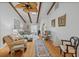 Bright living room with a beamed ceiling, hardwood floors, and comfortable furnishings at 2665 Sequoia Ter # 306, Palm Harbor, FL 34683
