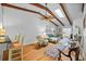 Open-concept living room with hardwood floors, a ceiling fan, and beamed vaulted ceiling at 2665 Sequoia Ter # 306, Palm Harbor, FL 34683
