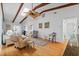 Bright living room featuring hardwood floors, a ceiling fan, skylights and beamed vaulted ceiling at 2665 Sequoia Ter # 306, Palm Harbor, FL 34683