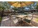 Community pool with seating, lounge chairs, shade umbrellas, and a dining area at 2665 Sequoia Ter # 306, Palm Harbor, FL 34683