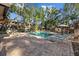 Community pool surrounded by lounge chairs and lush landscaping for a relaxing atmosphere at 2665 Sequoia Ter # 306, Palm Harbor, FL 34683