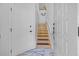 Bright stairway with wooden steps, white walls, and a unique tile floor at 2665 Sequoia Ter # 306, Palm Harbor, FL 34683