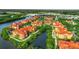 Aerial view of a community surrounded by lush landscape with multiple buildings and water views at 2724 Via Murano # 615, Clearwater, FL 33764