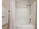 Clean bathroom featuring a combination shower and bathtub with a white shower curtain and chrome fixtures, plus towel rack at 2724 Via Murano # 615, Clearwater, FL 33764