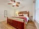 Comfortable bedroom features a tropical ceiling fan, a bed with decorative pillows, and ample natural light from the window at 2724 Via Murano # 615, Clearwater, FL 33764