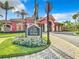 Attractive Villa Rialto clubhouse entrance surrounded by flowers and paved walkway at 2724 Via Murano # 615, Clearwater, FL 33764