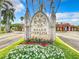 Well-maintained entrance sign displaying 'Grand Venezia' with colorful flowers at 2724 Via Murano # 615, Clearwater, FL 33764