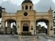 Elegant entrance gate with signage, manicured landscaping, and Mediterranean architecture at 2724 Via Murano # 615, Clearwater, FL 33764