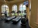 Bright gym featuring modern treadmills, elliptical machines and a TV at 2724 Via Murano # 615, Clearwater, FL 33764