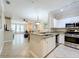 Bright kitchen featuring granite countertops, stainless steel appliances, and a seamless flow into the living area at 2724 Via Murano # 615, Clearwater, FL 33764