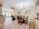 Open living area with a dining table, view of the kitchen, and large windows for natural light at 2724 Via Murano # 615, Clearwater, FL 33764