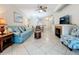 Comfortable living room with a blue sofa, fireplace, and tiled floors at 2724 Via Murano # 615, Clearwater, FL 33764