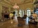 Grand lobby with elegant chandeliers, fireplace, seating, and ornate architecture at 2724 Via Murano # 615, Clearwater, FL 33764