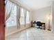 Bright office space featuring tiled floors, a work desk, and abundant natural light from large windows with elegant curtains at 2724 Via Murano # 615, Clearwater, FL 33764