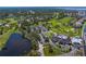 Wide aerial view showcasing the amenities of Pasadena Yacht & Country Club: tennis courts, pool, lake, and golf course at 2817 Seabreeze S Dr, Gulfport, FL 33707