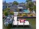 Aerial view of a waterfront property with a dock, pool, and well-manicured landscaping at 2817 Seabreeze S Dr, Gulfport, FL 33707