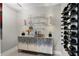 Modern bar area featuring wine storage, bar cabinet with liquor and glassware at 2817 Seabreeze S Dr, Gulfport, FL 33707