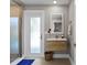 Bathroom featuring a floating vanity, walk-in shower, and stylish fixtures at 2817 Seabreeze S Dr, Gulfport, FL 33707